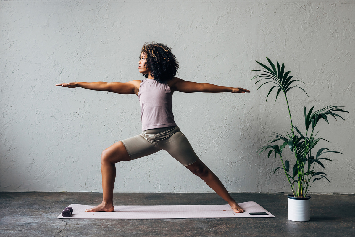 a woman doing yoga warrior pose after getting medical weight loss in San Antonio