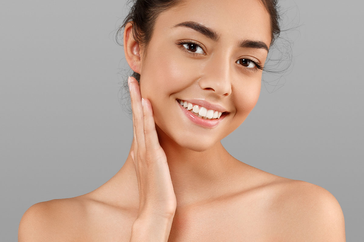 a woman smiling after getting a laser treatment in San Antonio.